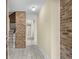 Inviting entryway featuring tiled flooring, brick wall accents, and a staircase leading to the upper level at 5616 N Kings Hwy., Myrtle Beach, SC 29577