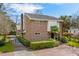 Inviting two-story brick home with mature landscaping, palm trees, and a manicured lawn at 5616 N Kings Hwy., Myrtle Beach, SC 29577