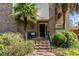 Charming brick home entrance featuring a small seating bench and well-manicured landscaping at 5616 N Kings Hwy., Myrtle Beach, SC 29577