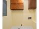Functional laundry room with overhead cabinets, hookups, and a convenient outlet at 5616 N Kings Hwy., Myrtle Beach, SC 29577