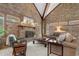 Spacious living room featuring a brick fireplace, vaulted ceilings with exposed beams, and comfortable seating at 5616 N Kings Hwy., Myrtle Beach, SC 29577