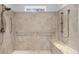 Roll-in shower featuring grab bars, a shower bench, and tiled walls at 5616 N Kings Hwy., Myrtle Beach, SC 29577