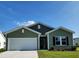 Charming single-story home with green siding, attached garage, well-manicured lawn, and inviting curb appeal at 119 Bolsin Ct, Conway, SC 29526
