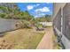 Private backyard retreat featuring a well-maintained lawn and brick-paved patio with comfortable chaise lounges for relaxation at 129 Waterfall Circle, Little River, SC 29566