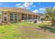 Spacious backyard featuring lush grass, a cozy patio with lounge chairs, and a screened-in porch for relaxed outdoor living at 129 Waterfall Circle, Little River, SC 29566