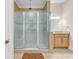 Modern bathroom featuring glass shower and wood vanity at 129 Waterfall Circle, Little River, SC 29566