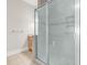 Bright bathroom with frameless glass shower and wood vanity at 129 Waterfall Circle, Little River, SC 29566