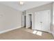 This bedroom has neutral paint, tiled floors, double door closet and trim at 129 Waterfall Circle, Little River, SC 29566