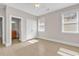 Bright bedroom features neutral paint, tiled floors, closet, and plenty of natural light at 129 Waterfall Circle, Little River, SC 29566