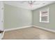 Bright bedroom features neutral paint, tiled floors, ceiling fan, and natural light at 129 Waterfall Circle, Little River, SC 29566