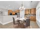 Open dining room with kitchen, modern lighting, and table staged in the space at 129 Waterfall Circle, Little River, SC 29566