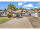 Charming brick home with a well-manicured lawn, large driveway and mature landscaping at 129 Waterfall Circle, Little River, SC 29566