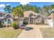 Charming brick home with a well-manicured lawn and a paved driveway leading to an attached garage at 129 Waterfall Circle, Little River, SC 29566