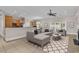 Living room with tile floors, fireplace, kitchen and furniture staged in the space at 129 Waterfall Circle, Little River, SC 29566