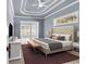 Comfortable main bedroom boasts trey ceiling and adjacent sitting area at 129 Waterfall Circle, Little River, SC 29566