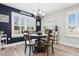 Cozy dining room with wood table and chairs, chandelier, and sunlit windows at 134 Winding Path Dr., Loris, SC 29569