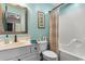 Inviting bathroom features blue walls, decorative mirror, and shower with a curved rod at 1551 Spinnaker Dr. # 5821, North Myrtle Beach, SC 29582