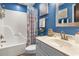 Bright blue bathroom with white cabinets, updated fixtures, and tub with shower combination at 1551 Spinnaker Dr. # 5821, North Myrtle Beach, SC 29582