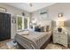 Well-lit bedroom features wood floors, dark door, and plantation shutters for style at 1551 Spinnaker Dr. # 5821, North Myrtle Beach, SC 29582