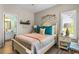 Charming bedroom with bright windows, wood floors, and adjacent bathroom for convenience at 1551 Spinnaker Dr. # 5821, North Myrtle Beach, SC 29582