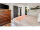 Comfortable bedroom features wood floors, decorative shelving, and adjacent bathroom at 1551 Spinnaker Dr. # 5821, North Myrtle Beach, SC 29582