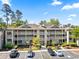 A condo building featuring balconies, a well-maintained landscape and ample parking space for residents and visitors at 1551 Spinnaker Dr. # 5821, North Myrtle Beach, SC 29582