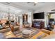 Spacious living room with comfortable seating, fireplace, television, and view into the dining area at 1551 Spinnaker Dr. # 5821, North Myrtle Beach, SC 29582