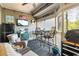 Comfortable screened porch with seating, a mini fridge, and backyard views at 1551 Spinnaker Dr. # 5821, North Myrtle Beach, SC 29582