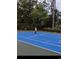 Brightly colored tennis court surrounded by trees. A perfect area to enjoy tennis games at 1551 Spinnaker Dr. # 5821, North Myrtle Beach, SC 29582