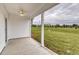 Covered patio with a ceiling fan overlooking a spacious, green backyard at 316 Dunlin Pl, Conway, SC 29526