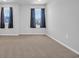 Clean bedroom with neutral walls and lake view windows with dark curtains at 3304 Candytuft Dr., Conway, SC 29526