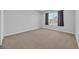 Neat bedroom with neutral carpet and a window overlooking the backyard at 3304 Candytuft Dr., Conway, SC 29526