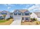 Two-story home with light blue siding and black shutters in a well-kept community at 3304 Candytuft Dr., Conway, SC 29526