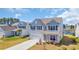 Charming two-story home with light blue siding, black shutters, and a well-manicured lawn at 3304 Candytuft Dr., Conway, SC 29526