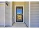 Close-up of a front door featuring a storm door and sidelight at 3304 Candytuft Dr., Conway, SC 29526