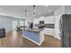 Modern kitchen with white cabinets, island with blue accents, and stainless steel appliances at 3304 Candytuft Dr., Conway, SC 29526