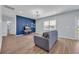 Cozy living room showcases a blue accent wall and water views through a large window at 3304 Candytuft Dr., Conway, SC 29526