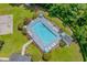 An aerial view of a community pool with multiple lounge chairs and well-manicured landscaping at 4305 Lotus Ct. # G, Murrells Inlet, SC 29576