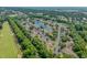 The aerial view showcases homes surrounded by trees, a tranquil pond, and a scenic golf course at 4305 Lotus Ct. # G, Murrells Inlet, SC 29576