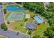 An aerial view of a community featuring a pool, tennis court, pond, and well-maintained clubhouse at 4305 Lotus Ct. # G, Murrells Inlet, SC 29576