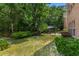 Private backyard space with a grill and patio, surrounded by lush greenery and mature trees at 4305 Lotus Ct. # G, Murrells Inlet, SC 29576