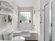 Bright bathroom featuring a shower, soaking tub, and window, with a wood-look floor at 4305 Lotus Ct. # G, Murrells Inlet, SC 29576
