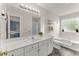 Well-lit bathroom features a large mirror, a soaking tub, and stylish fixtures at 4305 Lotus Ct. # G, Murrells Inlet, SC 29576