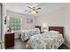 Comfortable bedroom with two beds, ceiling fan, and a window with natural light at 4305 Lotus Ct. # G, Murrells Inlet, SC 29576