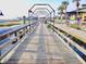 Inviting wooden boardwalk with overhead lighting and picturesque views of the marina and waterfront at 4305 Lotus Ct. # G, Murrells Inlet, SC 29576