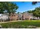 Charming condo exterior with brick facade, green lawn, and mature trees on a sunny day at 4305 Lotus Ct. # G, Murrells Inlet, SC 29576