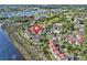 Aerial view showcasing condo community, lush landscape, pool, and proximity to water and golf at 4616 Greenbriar Dr. # H8, Little River, SC 29566