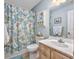 This bathroom features neutral wall paint, a toilet, and a shower with blue coral-themed curtain at 4616 Greenbriar Dr. # H8, Little River, SC 29566