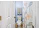 A half bath features a nautical themed shower curtain and a toilet at 4616 Greenbriar Dr. # H8, Little River, SC 29566