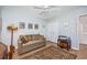 This home has a neutral bedroom that features an olive green sofa and a Tiffany style lamp at 4616 Greenbriar Dr. # H8, Little River, SC 29566